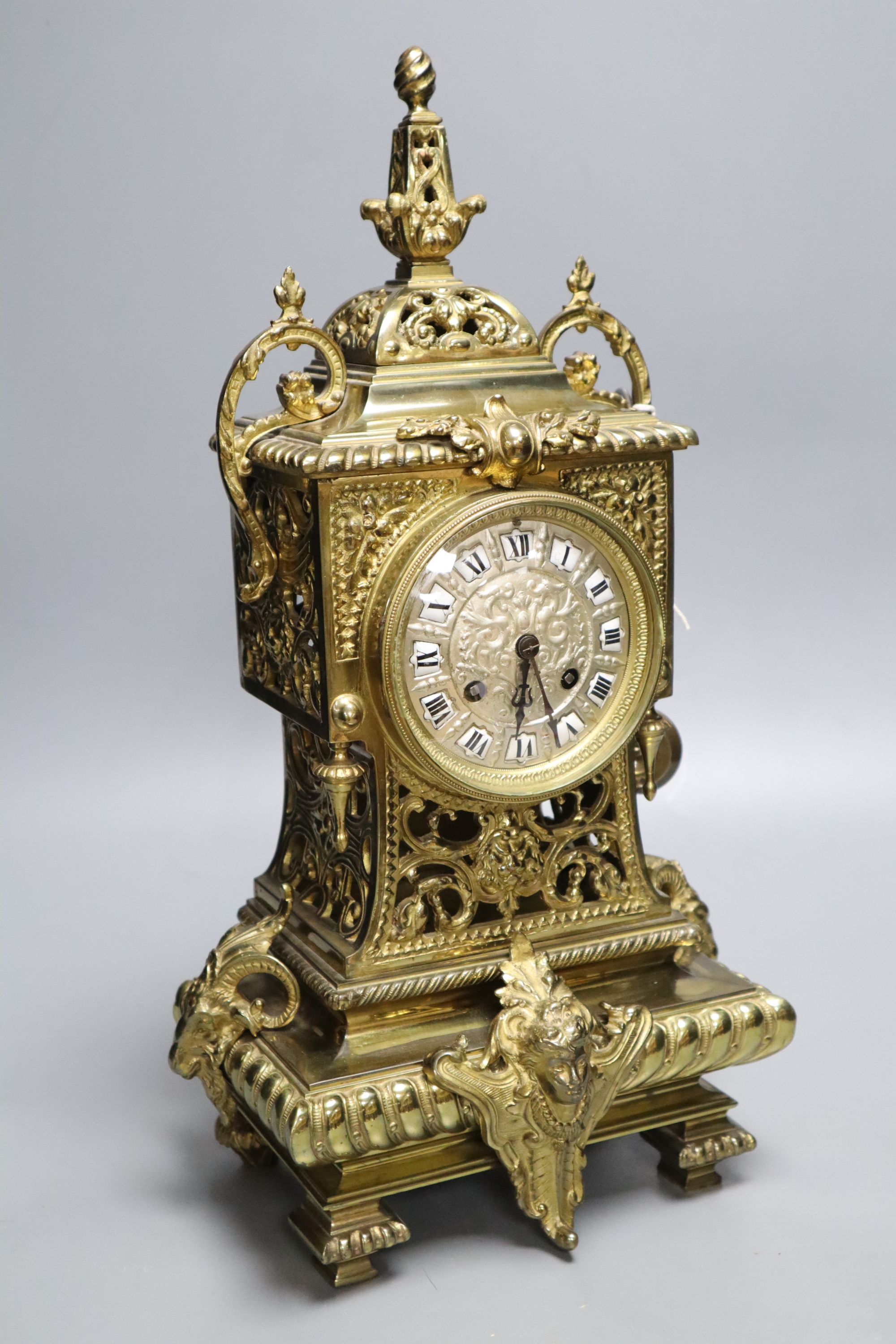 A French brass rococo-style mantel clock, with key and pendulum